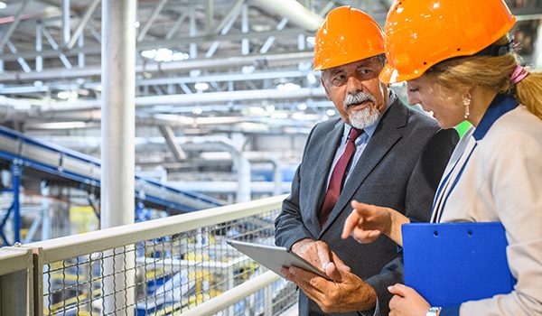 Two workers using OSHA checklist for workplace inspections